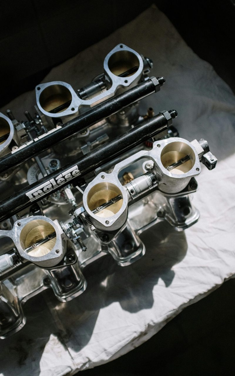 Close-up of high-performance engine parts on a fabric surface indoors.